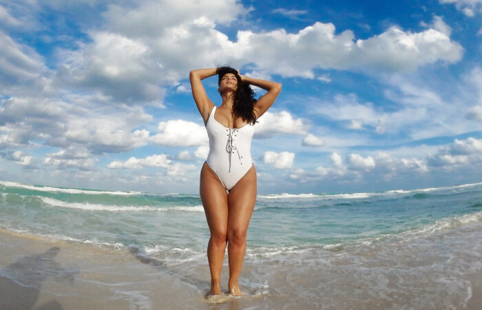 A curvy Super Model on the beach wearing a bikini swimsuit, for sports illustrated swim contest winner Michelle Vidal